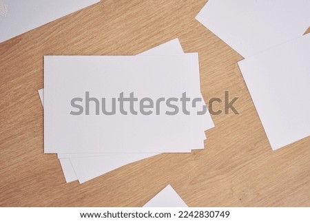 White note papers on a wooden table.                               
