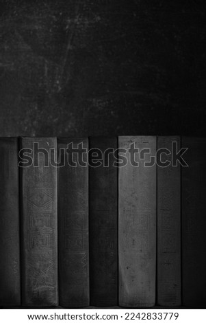 Row of old battered books on retro photos
