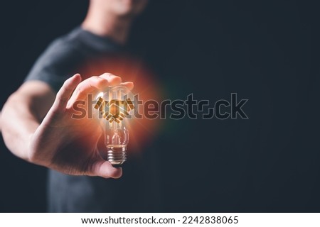 co-operation with ideas concept. Hands holding light bulb for Concept co-operation idea  with innovation and inspiration, innovative technology in science and communication concept, Royalty-Free Stock Photo #2242838065