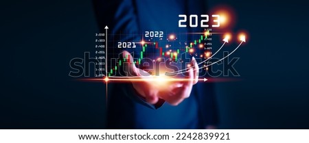Businessman hand touching and pointing on year 2023 with virtual screen from 2022 to 2023, Businessman plan and increase of positive indicators in his business, Growing up business concepts. Royalty-Free Stock Photo #2242839921