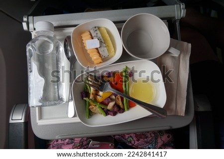Vegetarian Food At Airplane Board. The Place In The Asian Plane In Economy Class. Royalty-Free Stock Photo #2242841417