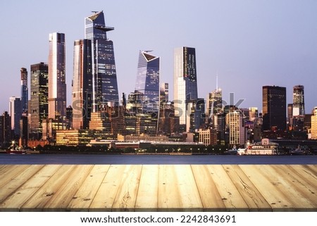Wooden tabletop with beautiful Manhattan skyscrapers at evening on background, mock up