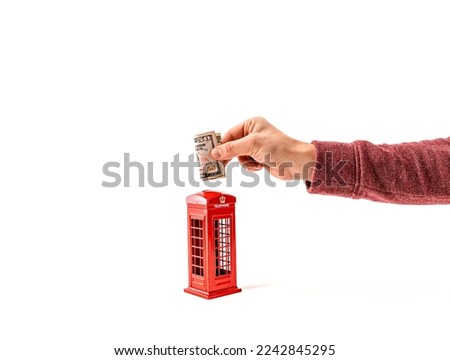 Close up man putting 50 dollar money into a moneybox, penny or piggy bank with calculator. Saving money for new house home, future, school, retirement. Saving money penny bank on white background