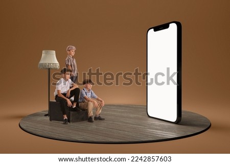 Stylish boys, children in retro clothes watching on huge 3D model of phone screen. Online education, shopping, cartoons. Concept of childhood, lifestyle, fun, education, game, modern technologies