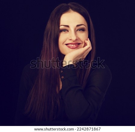 Beautiful happy smiling business woman with toothy smile in black shirt on black background with empty copy space. Closeup portrait of natural happiness. Front center view portrait. Toned color