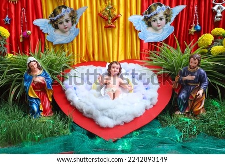 infant jesus is laying on cotton bed. Beutiful crib.