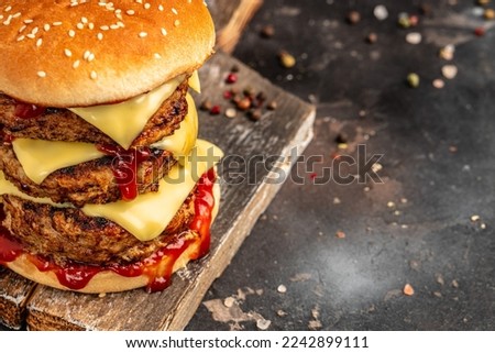 Burger with Double cutlet, double cheddar cheese, sauce and craft bun. fast food and junk food concept.