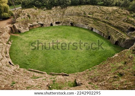 Sutri, Viterbo, Lazio, Italy: the Roman amphitheater, dug in the tufa rock 2000 years ago, in the park and archaeological site of the ancient town near Rome

 Royalty-Free Stock Photo #2242902295