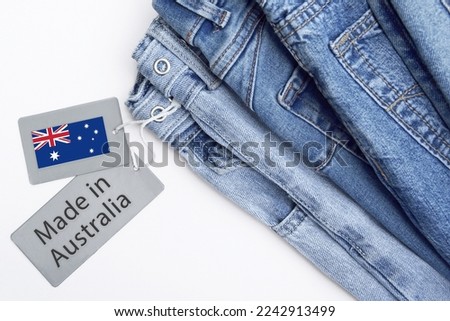 Detail of blue jeans, label and Made in Australia lettering. The concept of buying, selling, shopping and trendy modern clothes.