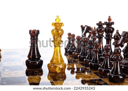 Natural amber different chess pieces figures standing on brown stone board. Close up game concept competition, Classic Gambit Tournament of confrontation.