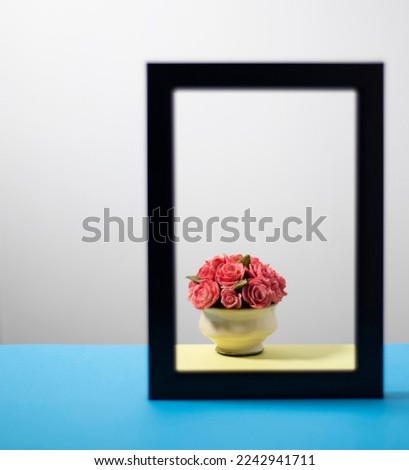 Still life of bouquet of roses framed on a blue surface 