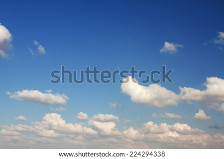 Beautiful white clouds on a blue sky background .