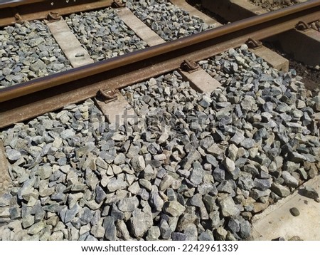 Iron Railway Train Track Rails With Rocky Ballast Bolts and Sleepers  Royalty-Free Stock Photo #2242961339