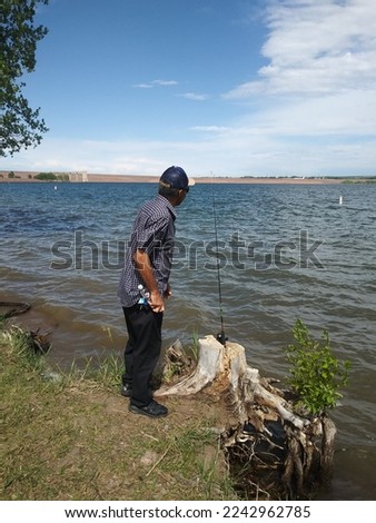View of Chatfield Reservoir and man fishing out side. One picture with game warden. One picture shows two men fishing