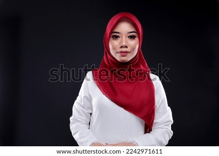 Fashionable young woman in long sleeves with hijab isolated over plain background. Stylish Muslim female hijab fashion lifestyle concept.