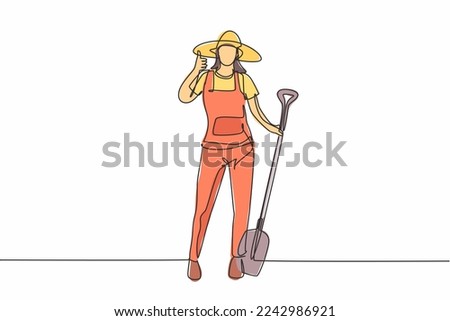 Single one line drawing of female farmer stood with a thumbs-up gesture, wearing a straw hat and carrying a shovel to plant crops on farmland. Continuous line draw design graphic vector illustration.