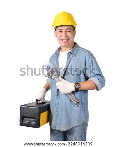 Asian tradesman holding adjustable wrench and tools box isolated on white background.
