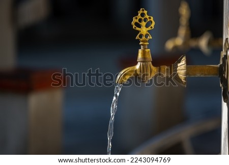 Turkish Ottoman style antique ablution tap at the ablution fountain outside of Valide Atik Mosque, Istanbul, Turkey, includes clipping path Royalty-Free Stock Photo #2243094769