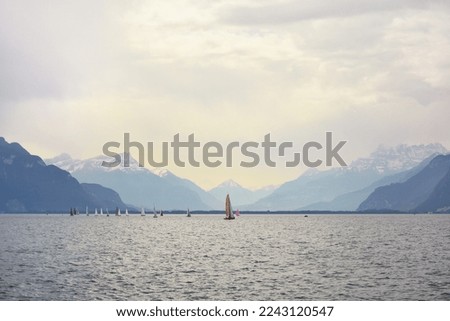 Boats on the lake Leman with the swiss Alps in the background, from Vevey, Switzerland