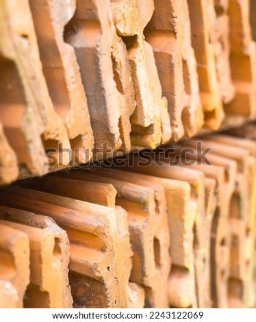 Orange roof tiles. Construction material. Roofing material. Stack of tiles. Close-up.