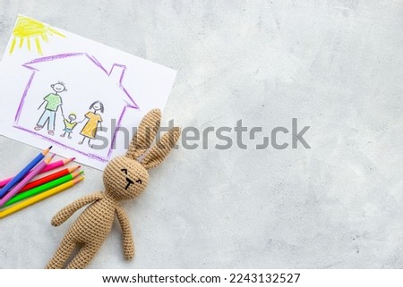 Childrens drawing of happy family with colored pencils