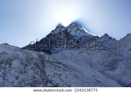 Rays of sun peeking out of snowy mountains.
Everest Range of the Himalayas, Nepal  Royalty-Free Stock Photo #2243138775