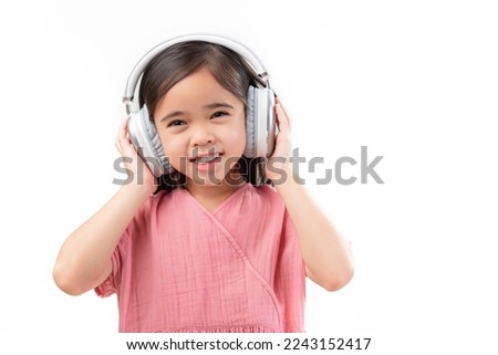 A little beautiful girl asia putting the headphone isolated on a white background.