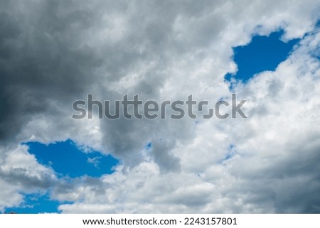 pattern of dark clouds with partly blue sky gives a creepy mood