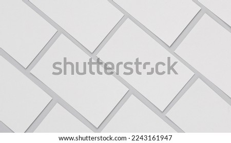 Many blank white business cards for branding on a gray background. Mockup for presentations, corporate identity and portfolios of graphic designers