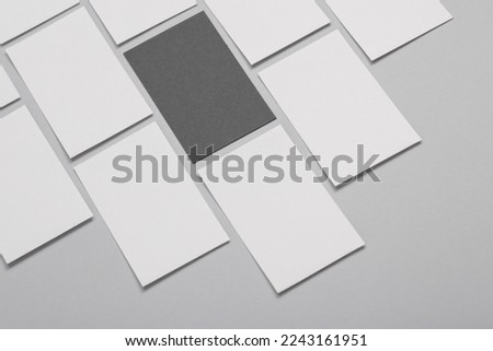 Many blank business cards for branding on a gray background. Mockup for presentations, corporate identity and portfolios of graphic designers