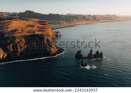 volcanic rock on the sea and vik town view in iceland