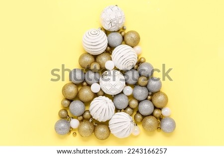 Christmas tree made of different balls on color background
