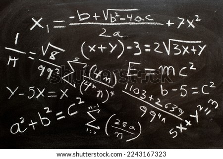 Mathematical formulas and equations written on a blackboard with chalk Royalty-Free Stock Photo #2243167323