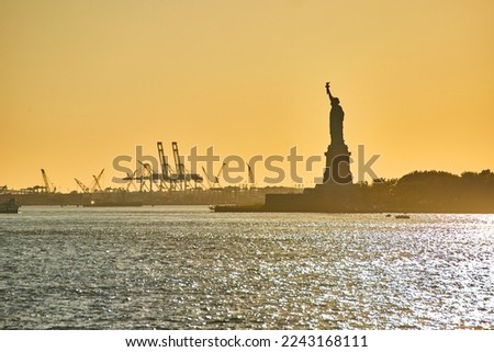 Beautiful Statue of Liberty in New York City with soft golden light and silhouette
