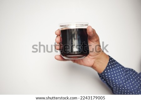 men holding a glass of soft drinks 