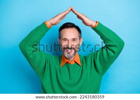 Portrait of positive person arms make roof gesture above head beaming smile isolated on blue color background Royalty-Free Stock Photo #2243180359
