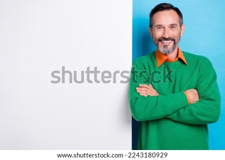 Photo of middle age grey beard man brunet hair folded hands near big banner empty space promo cheap bitcoin market isolated on blue color background