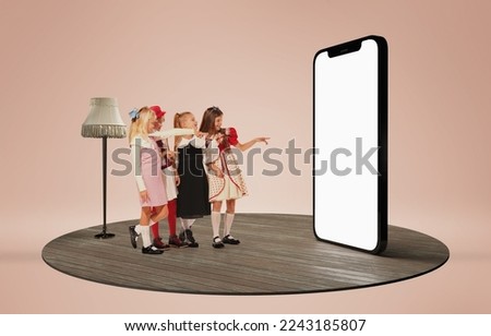 Stylish, cute, little girls, children looking on huge 3D model of phone screen and choosing clothes. Concept of childhood, lifestyle, fun, education, game, modern technologies. Ad, poster, text