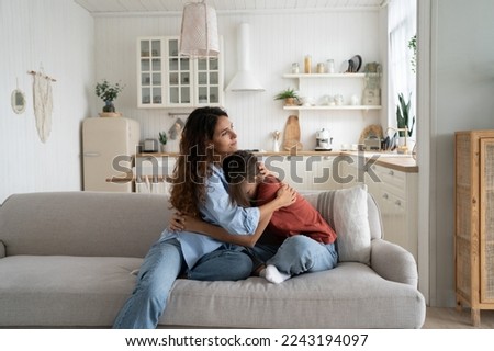 Loving caring mother hugging teen daughter. Parent mom showing understanding and support to upset sad teenage girl. Crying child sharing feelings with mommy while sitting together at home Royalty-Free Stock Photo #2243194097