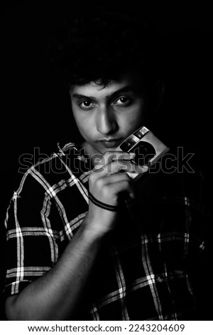 young boy wearing shirt , with camera looking front, black and white image