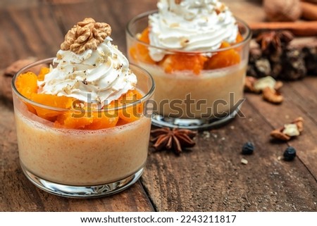 Creamy dessert with pumpkin mousse on a wooden background. place for text
