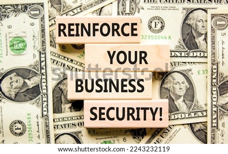 Reinforce your business security symbol. Concept word Reinforce your business security on blocks. Beautiful background from dollar bills. Business reinforce your business security concept. Copy space.