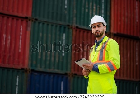 
The container loading foreman works confidently in the container yard. Workers are inspecting containers at container warehouse. Shipping. Import. Export. Industry concept. logistics business