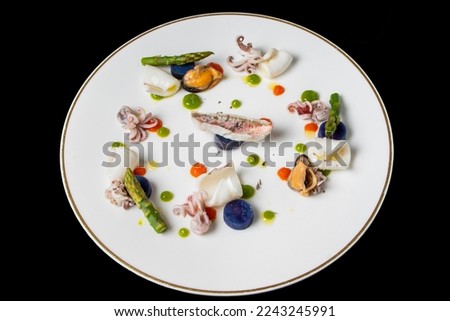 Steamed mullet, baby octopus and mussels with asparagus tips and blue beetroot