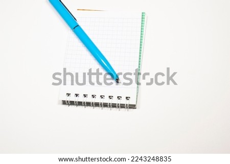 school notepad on blue background, spiral notepad on the table