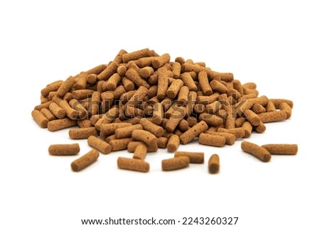 Food for animals and aquarium fish in grits on a white background. Pile of feed