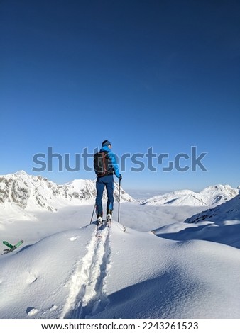 Man enjoying the beautiful view on the ski tour. Beautiful winter landscape with lots of snow in the alps. Mountaineering on Silberen Glarus Uri in Switzerland. High quality photo