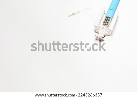 Selfie stick with an adjustable clip on the end on a white isolated background