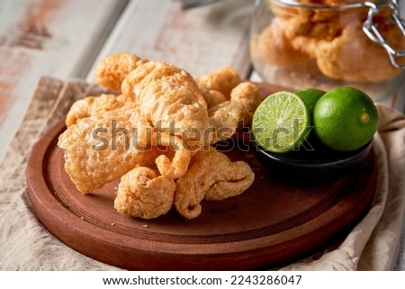 Pork rinds also known as chicharon or chicharrones, deep fried pork skin Royalty-Free Stock Photo #2243286047