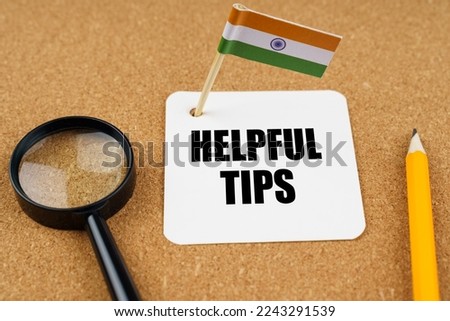 On the table is the flag of India, a pencil, a magnifying glass and a sheet of paper with the inscription - Helpful Tips